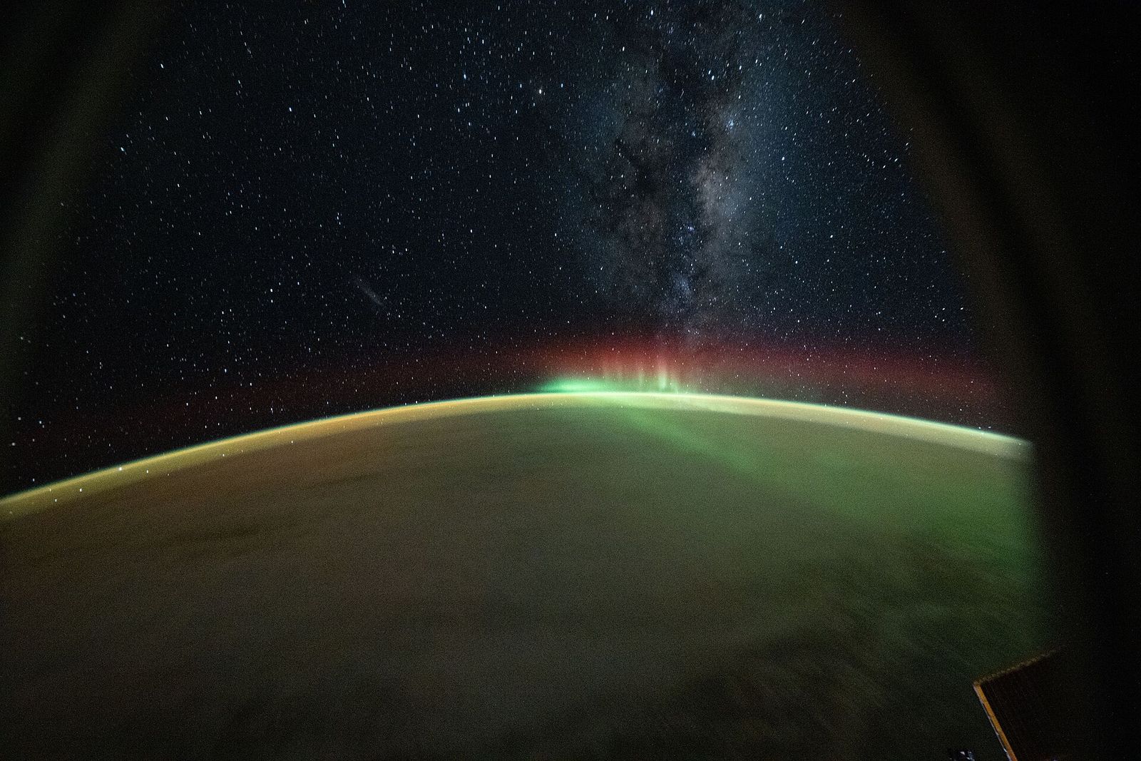 A green aurora australis over the Indian Ocean beneath the Milky Way