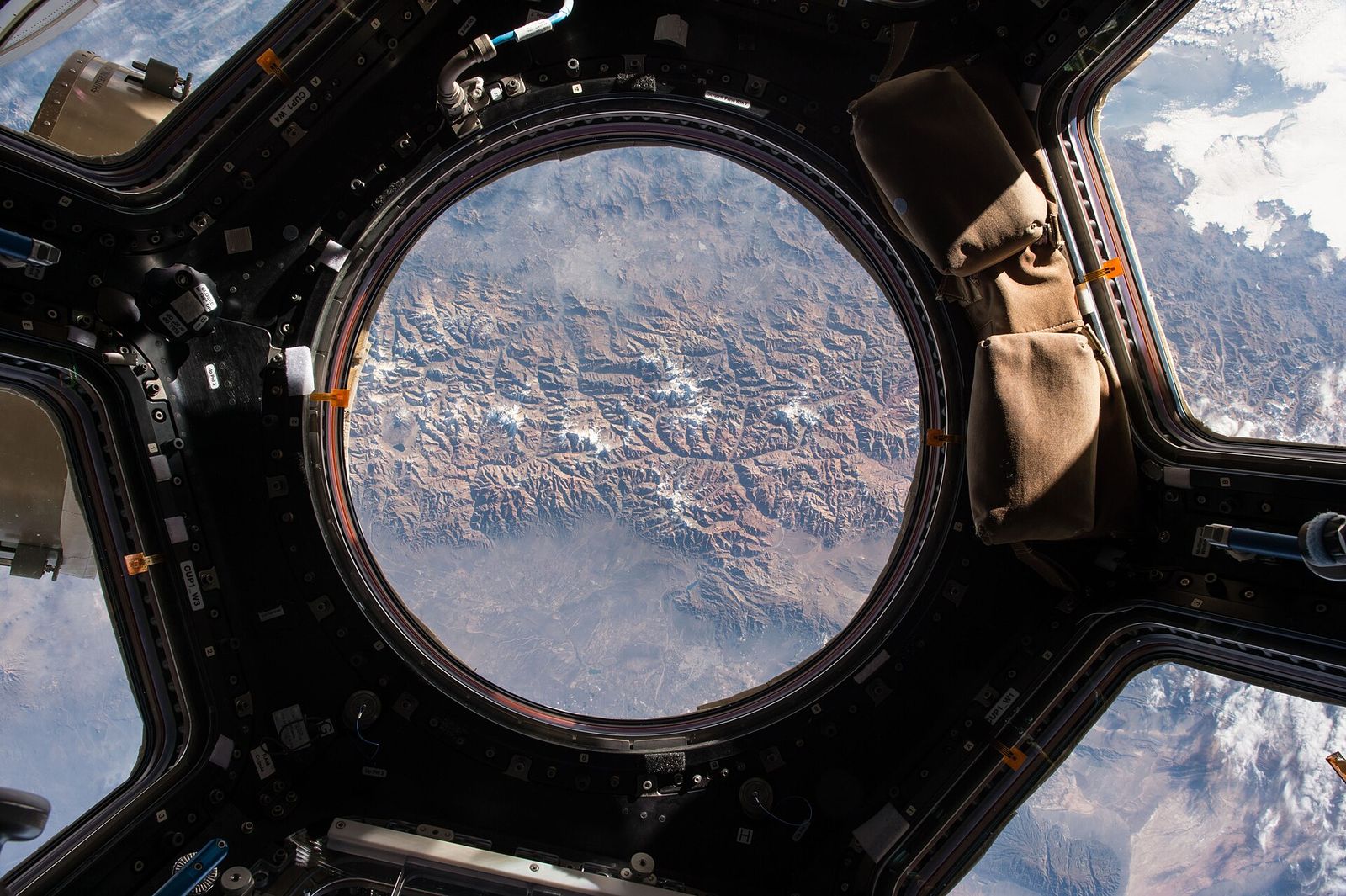 The Earth seen through a window of the station’s cupola